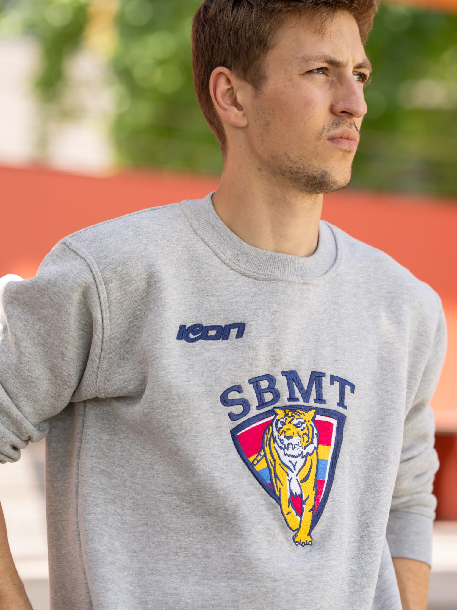 ICON crewneck with school crest worn by a model